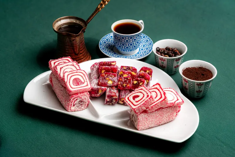 Rolled Turkish delight with coffee and a copper pot