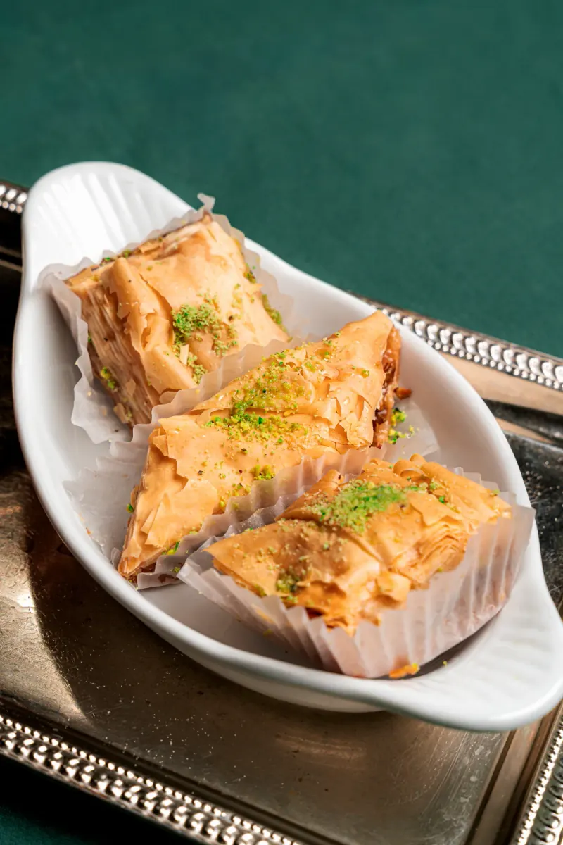 Layered baklava in a white dish
