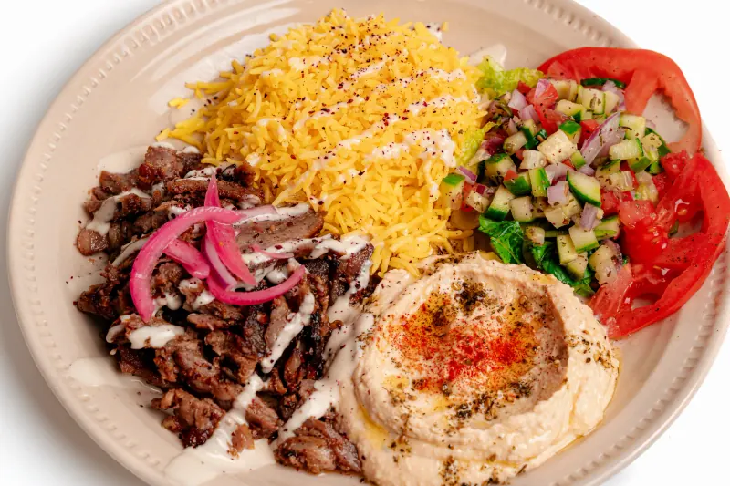 Shawarma with yellow rice, hummus and salad
